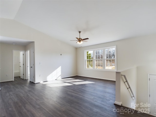 unfurnished living room featuring dark hardwood / wood-style flooring, vaulted ceiling, and ceiling fan