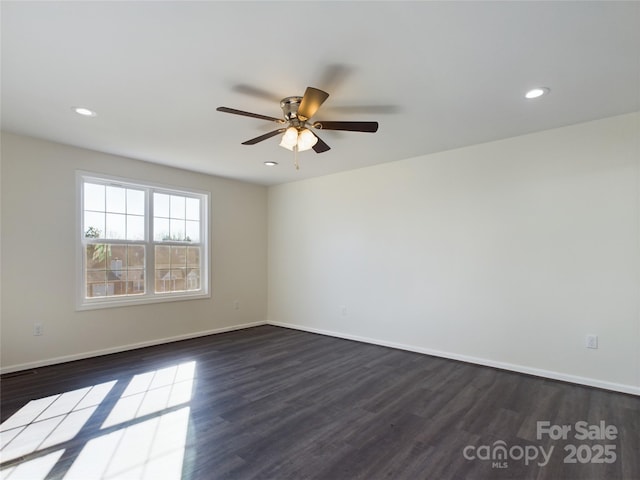 unfurnished room featuring ceiling fan and dark hardwood / wood-style flooring