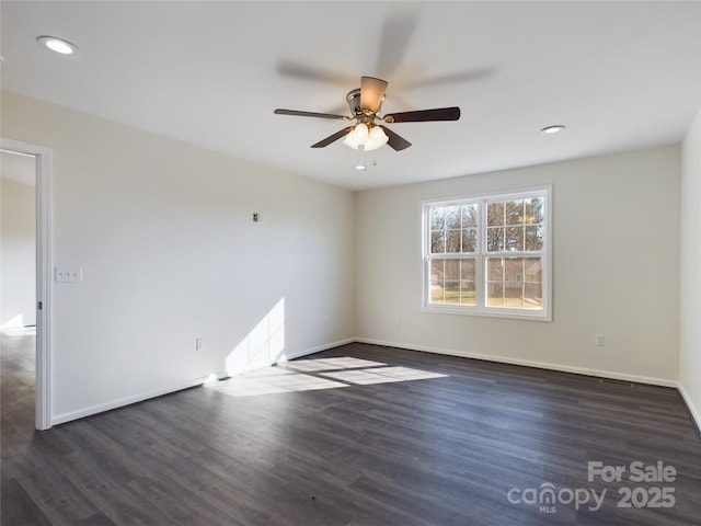 empty room featuring dark hardwood / wood-style floors and ceiling fan