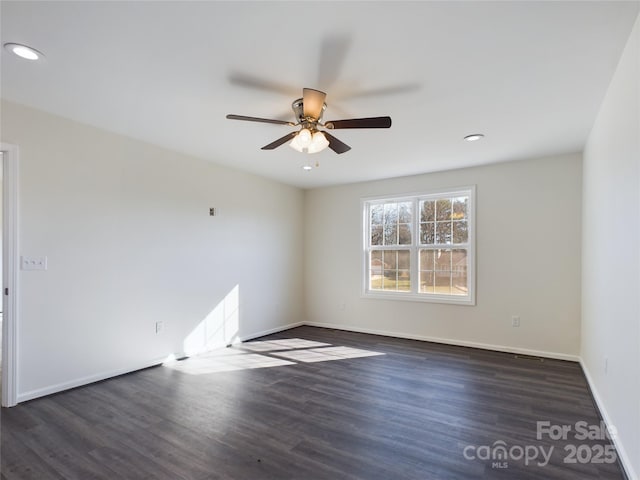 unfurnished room featuring dark hardwood / wood-style floors and ceiling fan