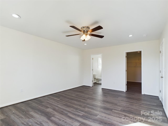 empty room featuring ceiling fan and dark hardwood / wood-style floors