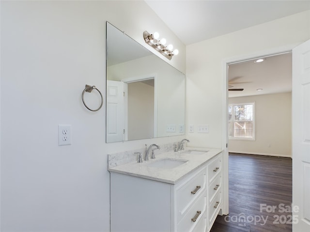 bathroom featuring hardwood / wood-style floors, ceiling fan, and vanity