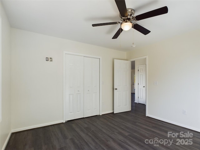 unfurnished bedroom featuring ceiling fan, a closet, and dark hardwood / wood-style floors