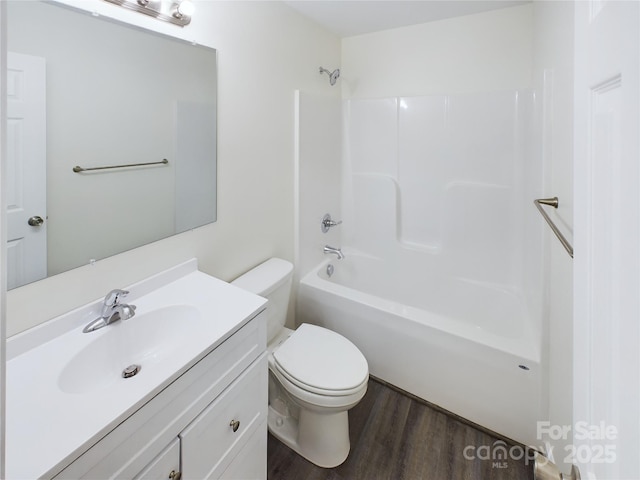 full bathroom featuring hardwood / wood-style floors, vanity, toilet, and tub / shower combination