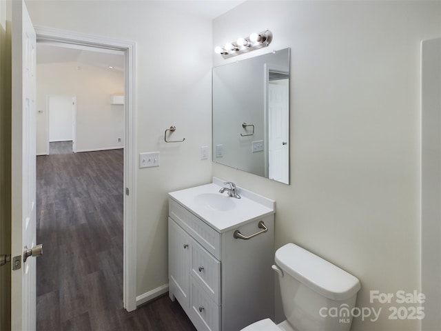 bathroom with vanity, toilet, and wood-type flooring