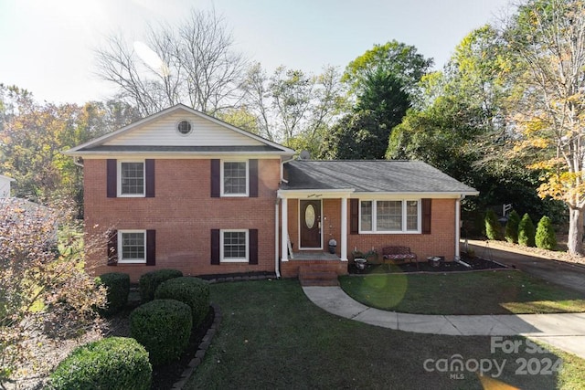 split level home featuring a front lawn