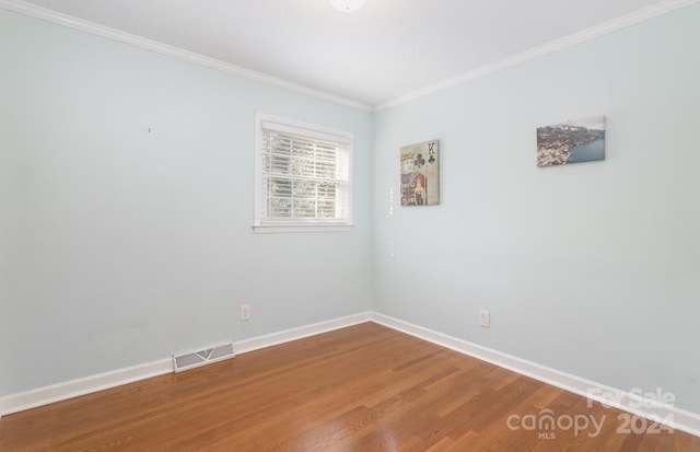 unfurnished room with wood-type flooring and crown molding