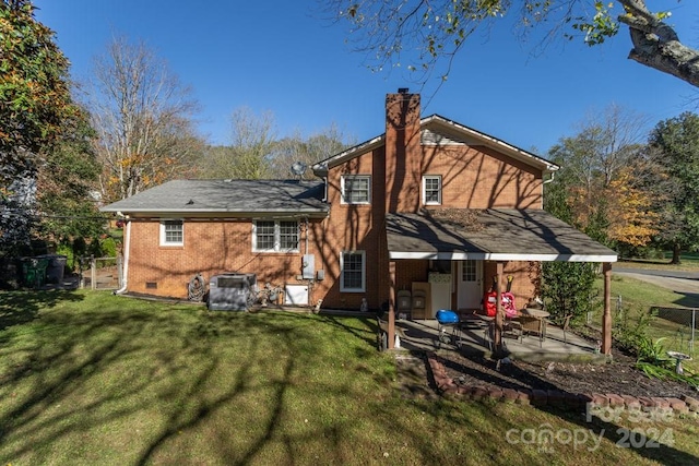 back of property featuring cooling unit, a yard, and a patio