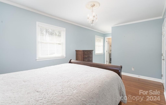 bedroom featuring hardwood / wood-style flooring, an inviting chandelier, and ornamental molding