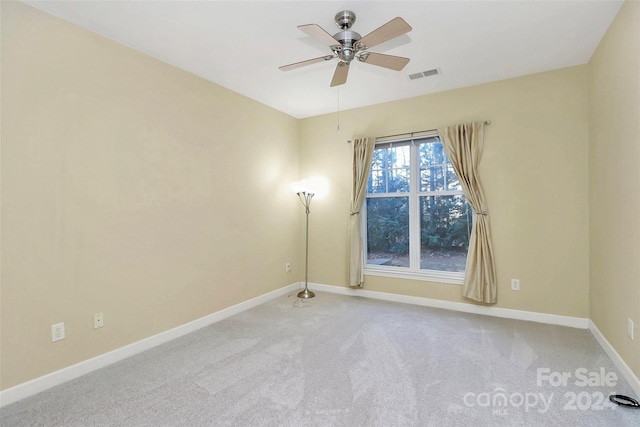 carpeted spare room featuring ceiling fan