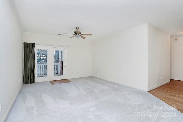 spare room with light hardwood / wood-style floors, ceiling fan, and ornamental molding