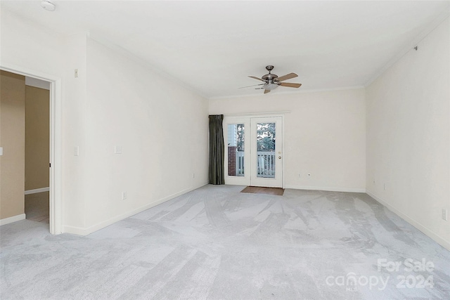 spare room featuring light colored carpet and ceiling fan