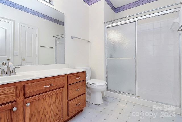 bathroom featuring vanity, toilet, and walk in shower