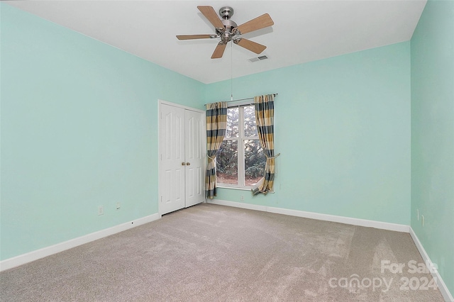 spare room with carpet floors and ceiling fan