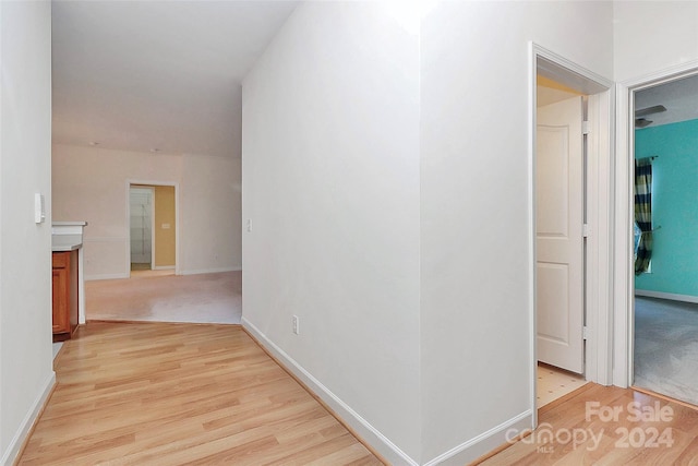 corridor with light hardwood / wood-style floors