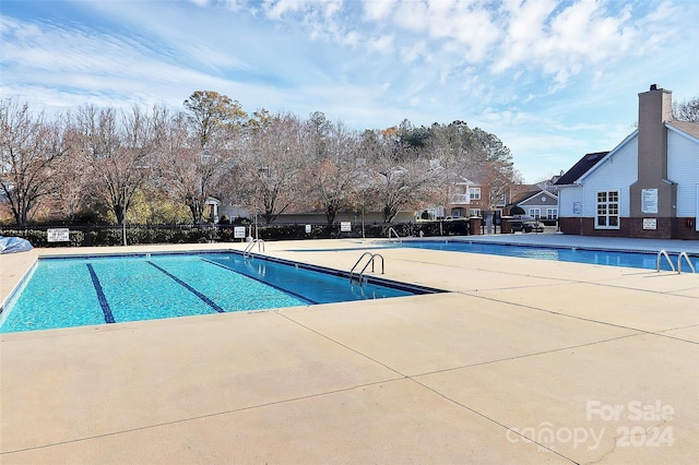 view of swimming pool featuring a patio area