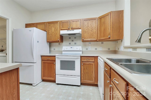 kitchen with tasteful backsplash, washer / clothes dryer, sink, and white appliances