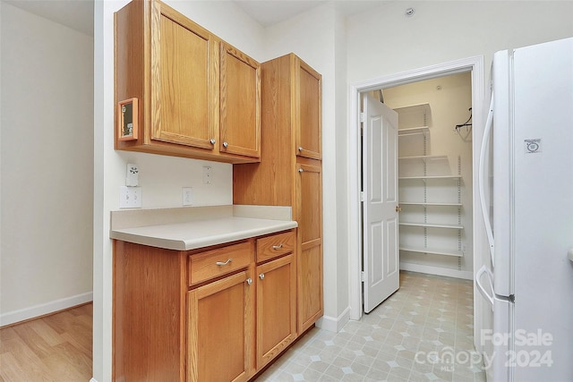 kitchen featuring light hardwood / wood-style floors and white refrigerator