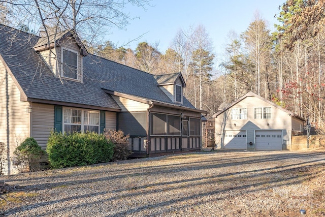 rear view of property featuring a sunroom