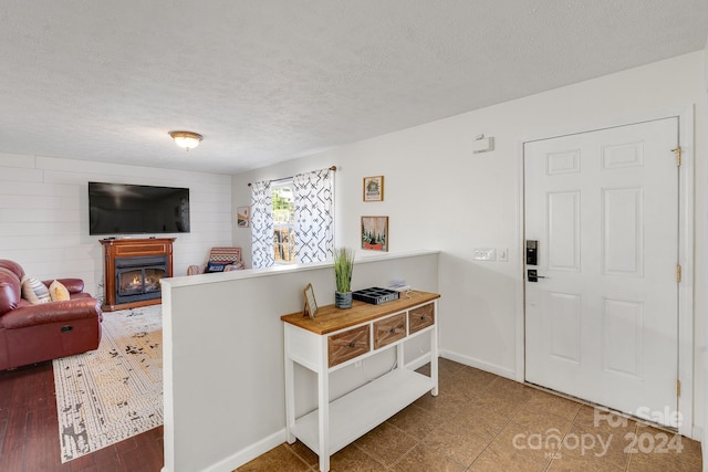 entryway featuring hardwood / wood-style floors and a textured ceiling