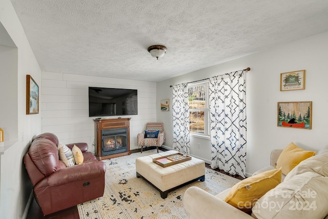 living room with a fireplace and a textured ceiling