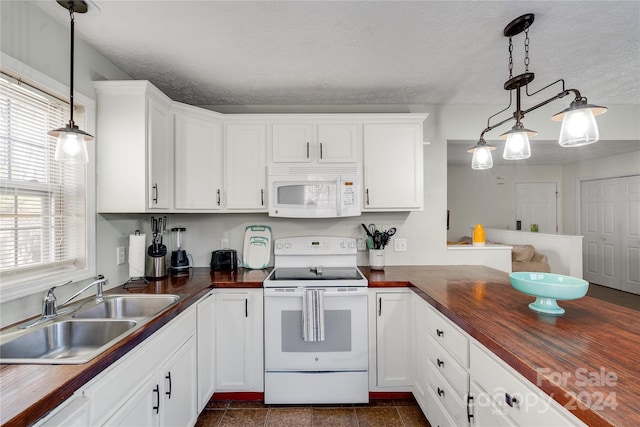 kitchen with sink, butcher block countertops, pendant lighting, a textured ceiling, and white appliances