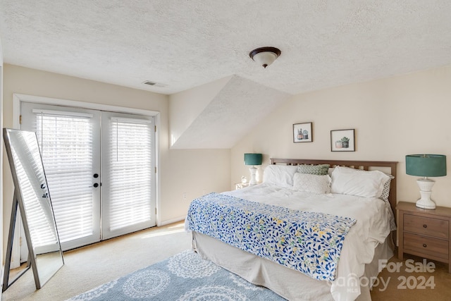 bedroom with access to exterior, a textured ceiling, light colored carpet, and lofted ceiling