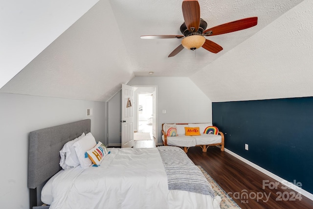 bedroom featuring a textured ceiling, hardwood / wood-style flooring, ceiling fan, and lofted ceiling