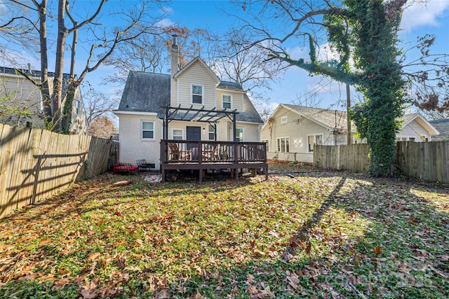 back of property featuring a pergola and a deck