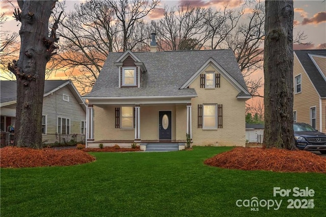 view of front of home featuring a lawn and a porch