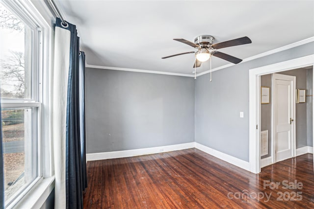 unfurnished room featuring crown molding, plenty of natural light, and dark wood-type flooring