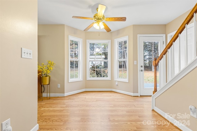 interior space featuring ceiling fan and a wealth of natural light