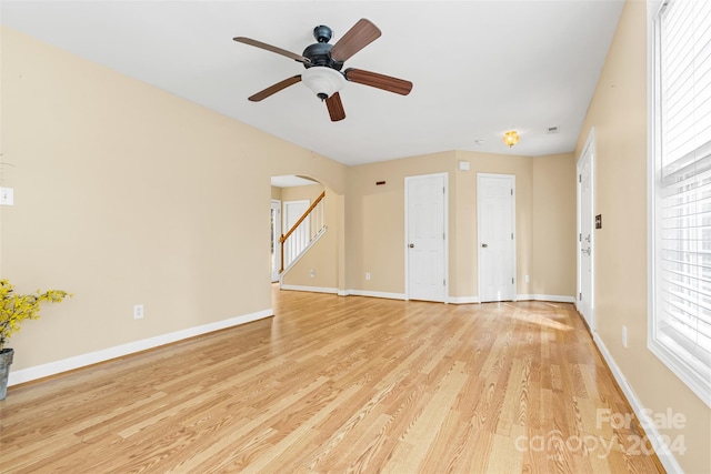 unfurnished living room with ceiling fan and light hardwood / wood-style flooring