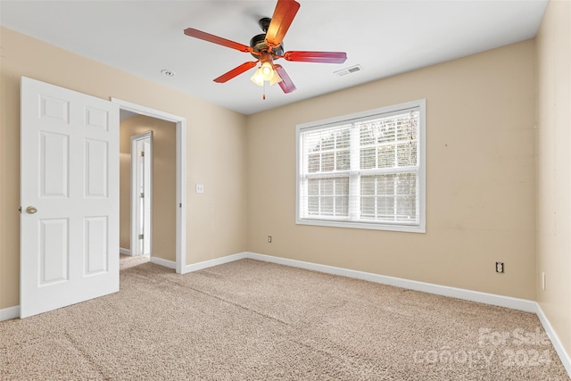 unfurnished bedroom with light colored carpet and ceiling fan