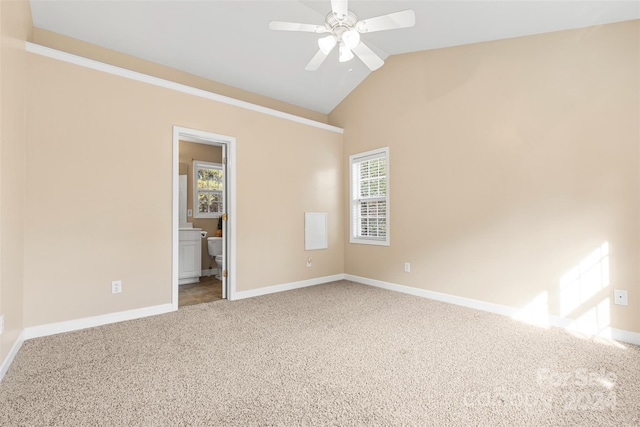 unfurnished bedroom with carpet flooring, ensuite bath, ceiling fan, and lofted ceiling