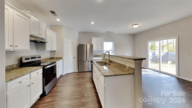 kitchen with white cabinets, a center island with sink, sink, dark hardwood / wood-style floors, and appliances with stainless steel finishes