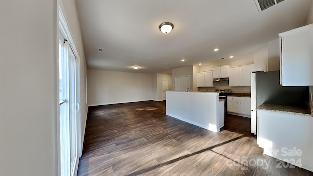 kitchen with white cabinets, a center island, and dark wood-type flooring