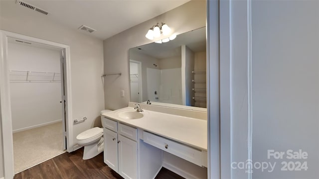 bathroom featuring hardwood / wood-style flooring, vanity, and toilet