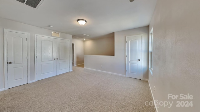 unfurnished bedroom with light carpet