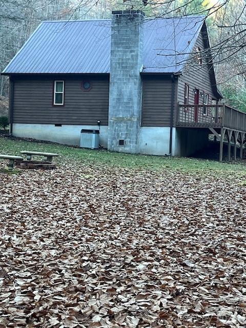 rear view of property featuring central air condition unit and a deck