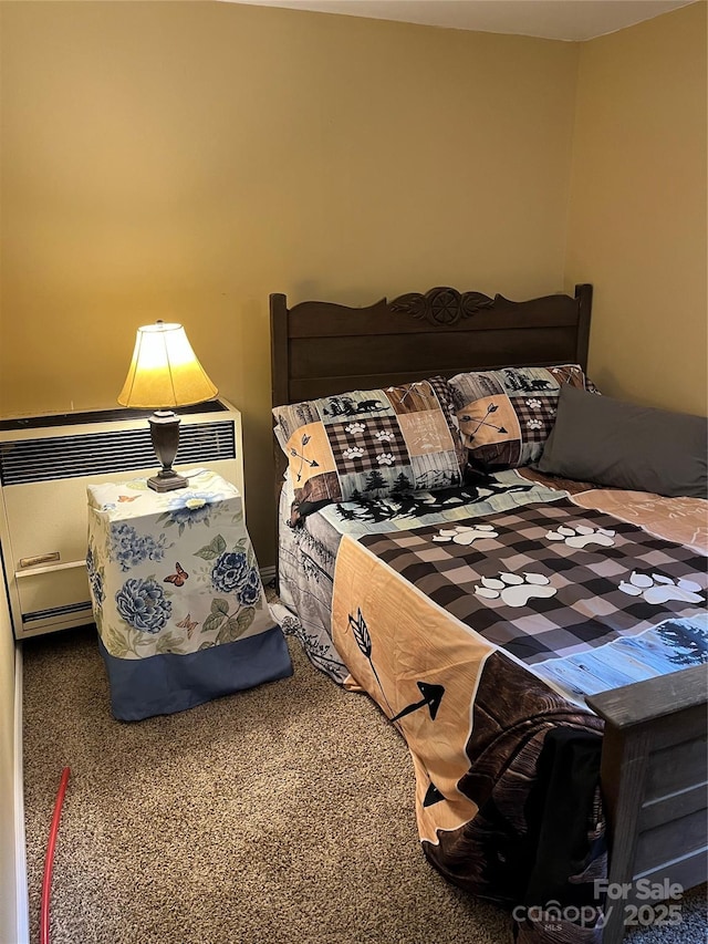 bedroom with radiator heating unit and carpet