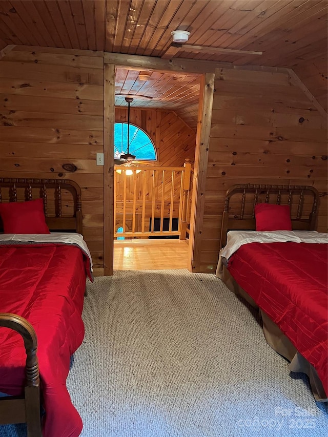 bedroom featuring lofted ceiling, wooden ceiling, and wood walls