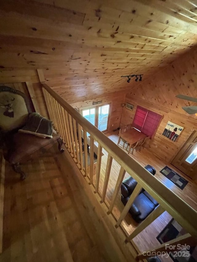 bonus room with wood-type flooring, lofted ceiling, wooden ceiling, and wooden walls