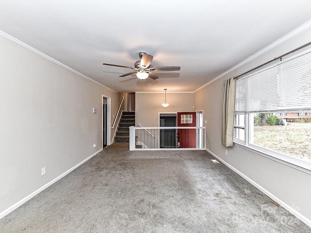 carpeted empty room featuring ceiling fan and crown molding