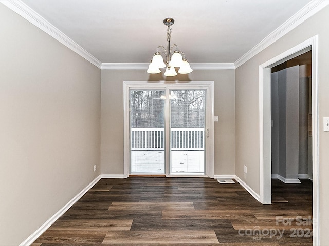 unfurnished dining area featuring ornamental molding, dark wood-type flooring, and a chandelier