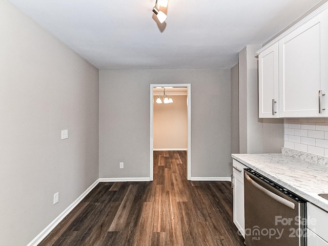 kitchen featuring dark hardwood / wood-style flooring, stainless steel dishwasher, backsplash, a chandelier, and white cabinets