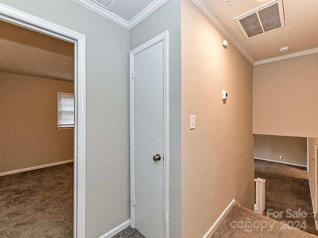 hallway with dark carpet and ornamental molding