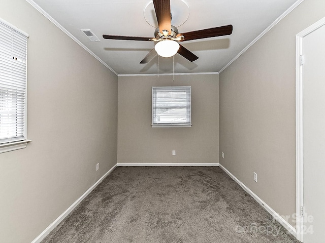 spare room with a wealth of natural light, crown molding, carpet, and ceiling fan