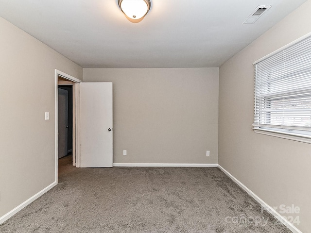 unfurnished room featuring carpet