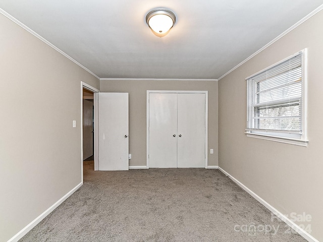 unfurnished bedroom featuring light colored carpet, a closet, and ornamental molding